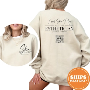 May include: Cream-colored sweatshirt with the text "Skin THERAPIST" on the front and "Local Skin Plug EST. 2025 ESTHETICIAN" on the back. Includes a QR code and the text "@custom.text.here" and "@custom.here".