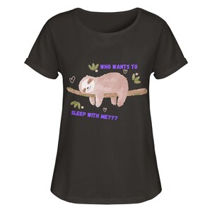 Könnte beinhalten: Schwarzes T-Shirt mit einem Cartoon-Faultier, das auf einem Ast schläft. Der Text "Wer will mit mir schlafen???" ist auf das Shirt gedruckt.
