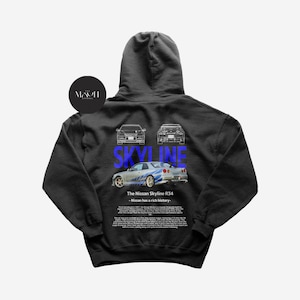 May include: Black hooded sweatshirt with a white outline of a Nissan Skyline R34 car and the text "SKYLINE" in blue. The text "The Nissan Skyline R34 - Nissan has a rich history." is printed below the car.
