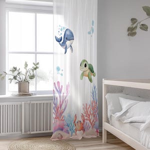 May include: White sheer curtain with a watercolor design of a blue whale, a green turtle, and a red crab in a coral reef setting.