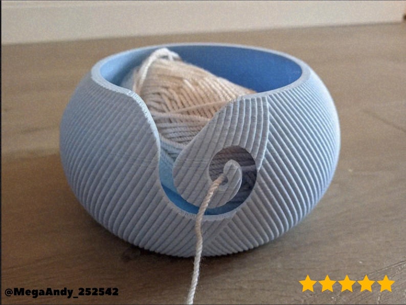 A 3D printable Yarn Ball Yarn Bowl designed to look like a ball of wool. Perfect for keeping yarn tangle-free while knitting or crocheting. Stylish and functional craft organizer made for 3D Printing - Blender Modeling - BambuLab - Limited Edition, Only Few Left.