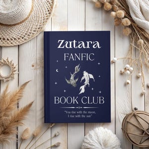 May include: A blue book with the title "Zutara FANFIC BOOK CLUB" and the quote "You rise with the moon, I rise with the sun". The book cover features a stylized illustration of two koi fish swimming in opposite directions.