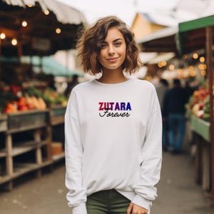May include: White sweatshirt with a red, blue, and purple graphic that says "Zutara Forever".