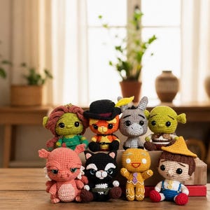 May include: A collection of eight crocheted stuffed characters including a green ogre, a cat in a black hat, a grey donkey, a green ogre with ears, a pink dragon, a black and white cat, a gingerbread person, and a boy in a yellow hat.