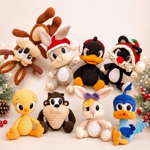 May include: A collection of eight crocheted stuffed animal figures featuring various cartoon-inspired characters. The set includes a brown monkey, a gray rabbit in a Santa hat, a black duck, a black cat in a Santa hat, a yellow bird, a brown creature, a light-colored rabbit with a purple bow, and a blue bird.