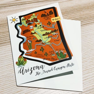 May include: A stylized map of Arizona with the text "Arizona, The Grand Canyon State" and a yellow sun in the top left corner. The map is orange and brown with black outlines and features various landmarks and cities including the Grand Canyon, Monument Valley, Sedona, Phoenix, and Yuma.