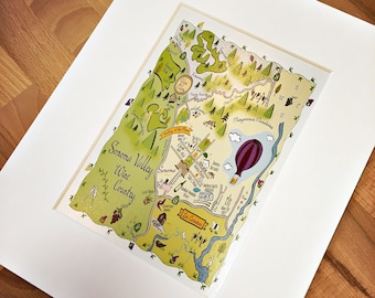 May include: A hand-drawn map of Sonoma Valley Wine Country in California. The map features a hot air balloon, vineyards, and the text "Sonoma Valley Wine Country".