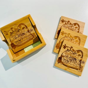 May include: Bamboo coasters with a heart-shaped map of San Jose, California, and the text "San Jose, The Valley of the Heart's Delight." The coasters are in a matching bamboo holder.
