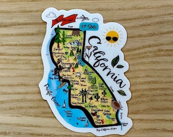 May include: A colorful illustrated map of California with the state's name written in a cursive font. The map includes major cities, landmarks, and national parks. The map is surrounded by a blue border with the words "Pacific Ocean" and "The Golden State" written on it. The map is on a wooden background.