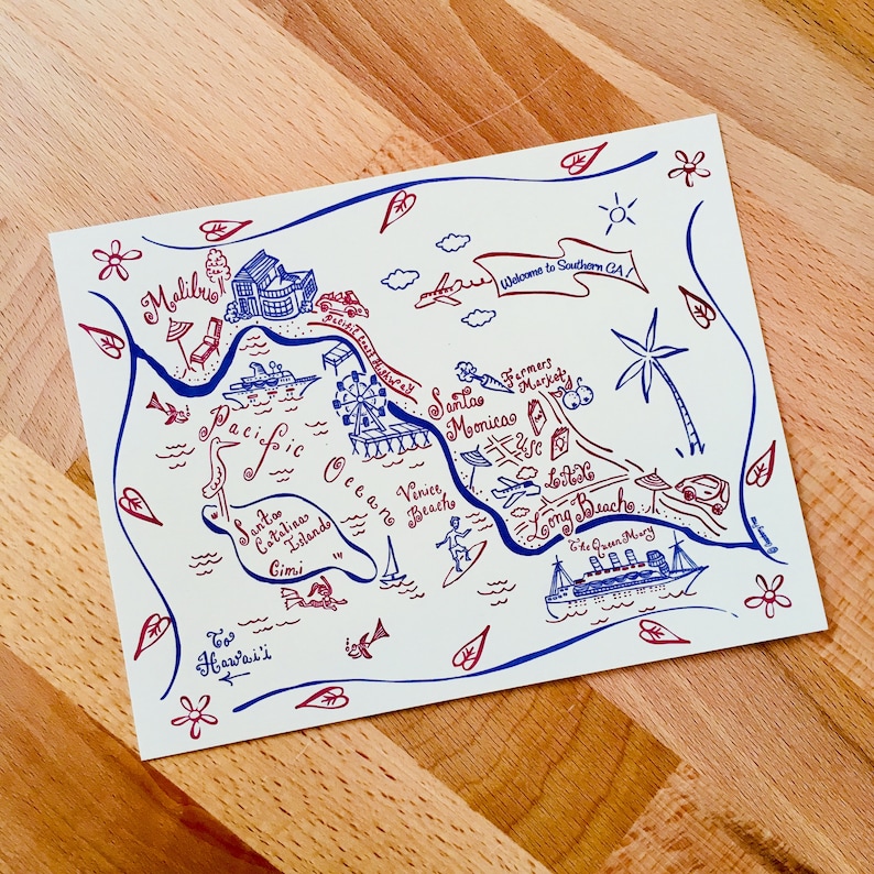 May include: A hand-drawn map of Southern California with blue and red ink. The map features landmarks like Santa Monica, Venice Beach, Long Beach, Catalina Island, and Malibu. The text "Welcome to Southern CA!" is written in a banner at the top of the map.