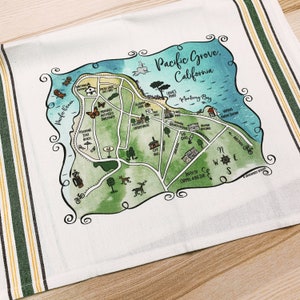 May include: A watercolor illustration of a map of Pacific Grove, California. The map shows the location of Monterey Bay, Lovers Point, the Pacific Ocean, and other landmarks. The map is surrounded by a decorative border.