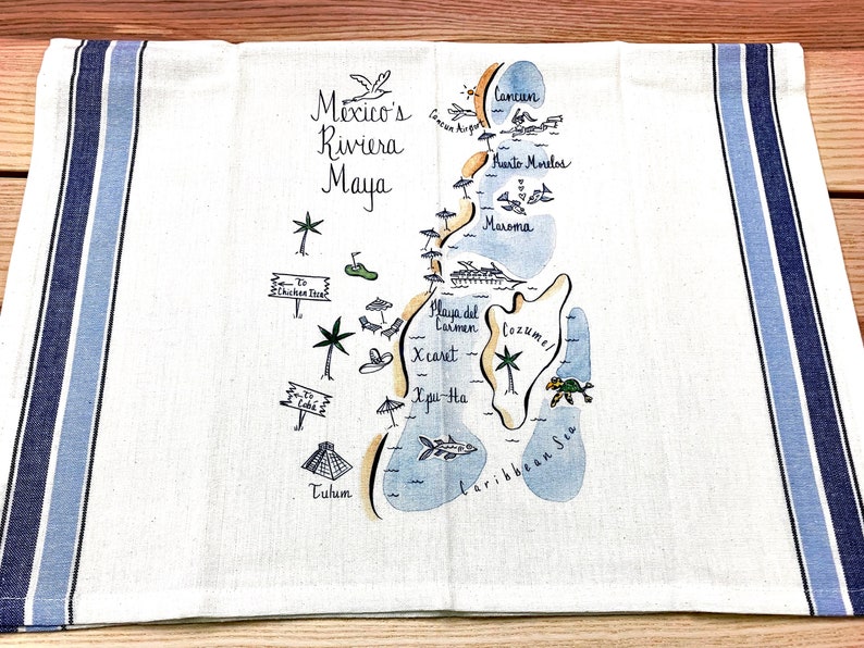 May include: A white kitchen towel with blue stripes features a hand-drawn map of Mexico's Riviera Maya. The map includes locations like Cancun, Playa del Carmen, Cozumel, and Tulum. The towel is ideal for adding a touch of coastal charm to your kitchen.