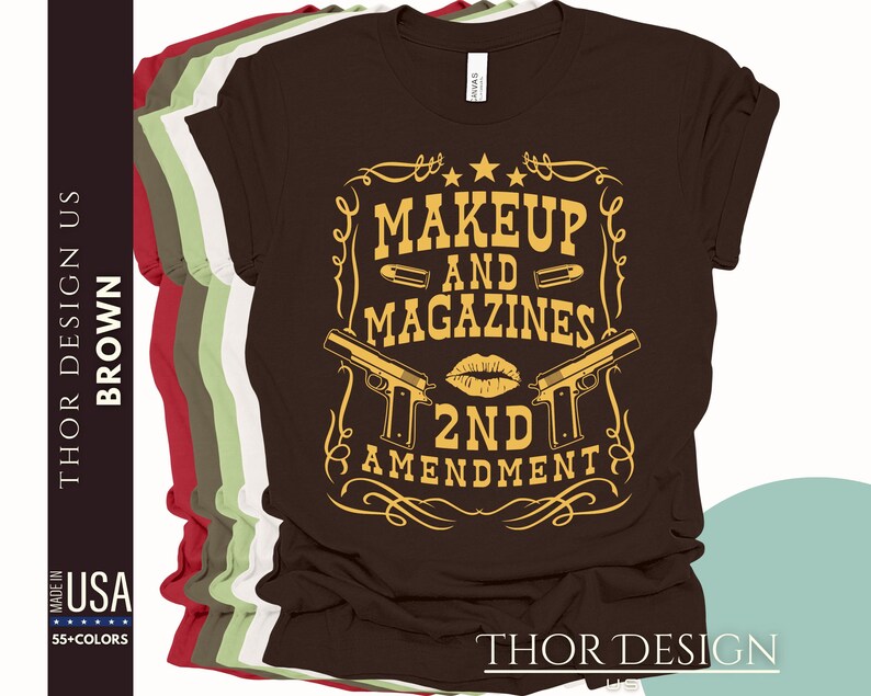 May include: Brown t-shirt with a gold graphic design that says "Makeup and Magazines 2nd Amendment". The graphic features two pistols and a lipstick kiss.