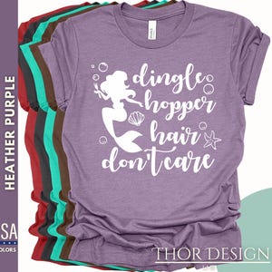 May include: Purple t-shirt with a white graphic of a mermaid with the text "dingle hopper hair don't care".