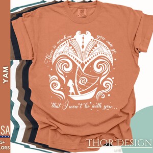 May include: A rust-colored t-shirt with a white graphic design. The graphic features a stylized island with a boat and a person standing on the boat. The text "There is nowhere you can go that I won't be with you..." is printed below the graphic.
