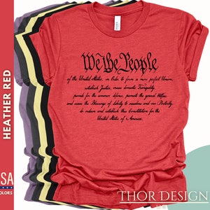 May include: Red heather t-shirt with black text that reads "We the People" followed by the preamble to the United States Constitution.