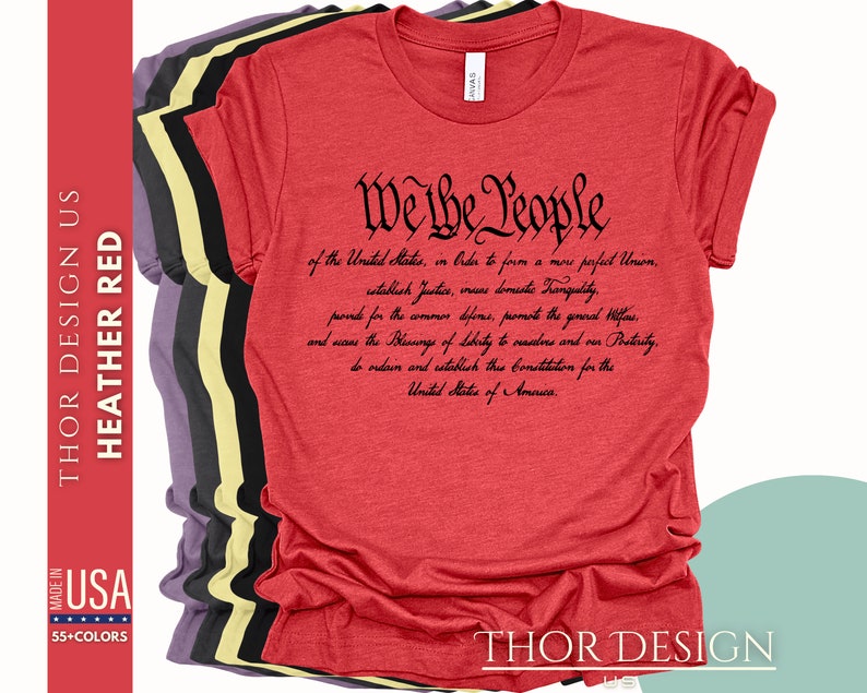 May include: Red heather t-shirt with black text that reads "We the People" followed by the preamble to the United States Constitution.