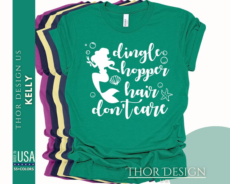 May include: Green t-shirt with a white mermaid graphic and the text "dingle hopper hair don't care".