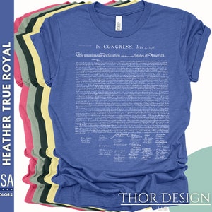 May include: A blue t-shirt with the full text of the Declaration of Independence printed in white. The text includes the date "July 4, 1776" and the signatures of the founding fathers. The shirt is available in a variety of colors.