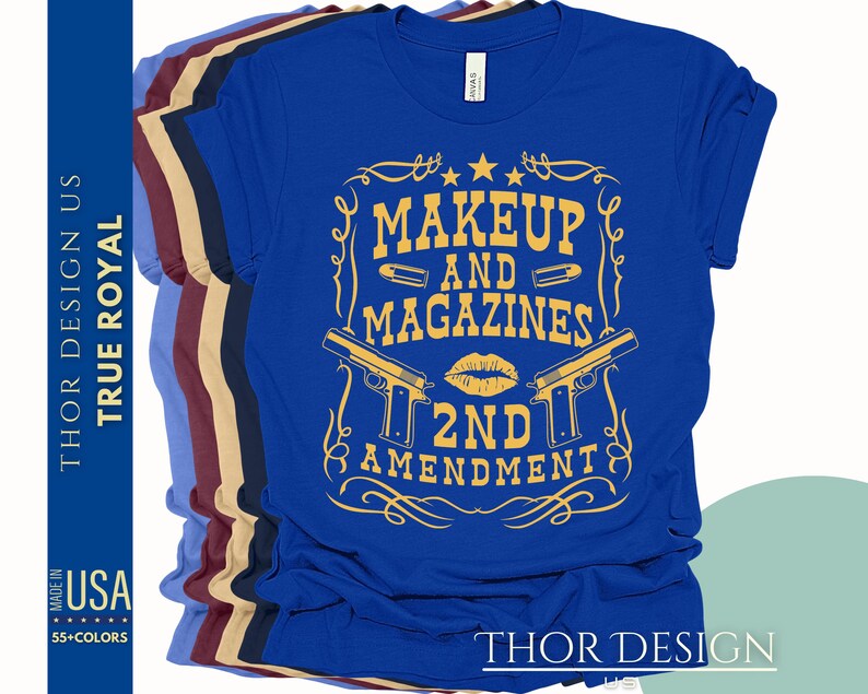 May include: Blue t-shirt with a gold graphic design that says "Makeup and Magazines 2nd Amendment". The graphic includes a lipstick kiss, two pistols, and bullets.