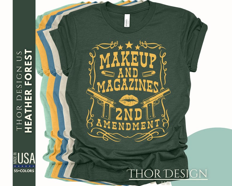 May include: A green t-shirt with a yellow graphic design that says "Makeup and Magazines 2nd Amendment". The graphic features two guns and a lipstick kiss.
