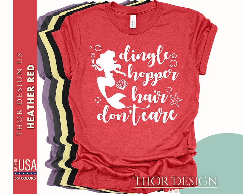 May include: Red t-shirt with a white graphic of a mermaid with the text "dingle hopper hair don't care".