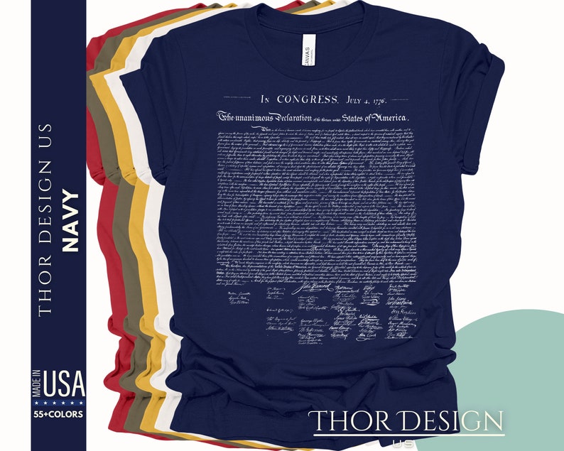 May include: A navy blue t-shirt with a white print of the Declaration of Independence. The text includes the date "July 4, 1776" and the phrase "The unanimous Declaration of the thirteen united States of America."