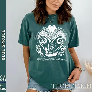 May include: A teal blue t-shirt with a white graphic of a girl sailing away on a boat with the text "There is nowhere you can go that I won't be with you..."