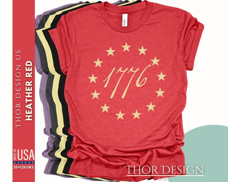 May include: Red heather t-shirt with a circle of stars and the number 1776 in a gold script font.