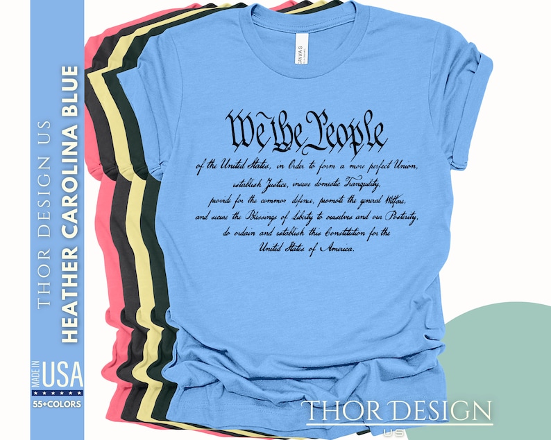 May include: A light blue t-shirt with black text that reads "We the People" followed by the preamble to the United States Constitution.
