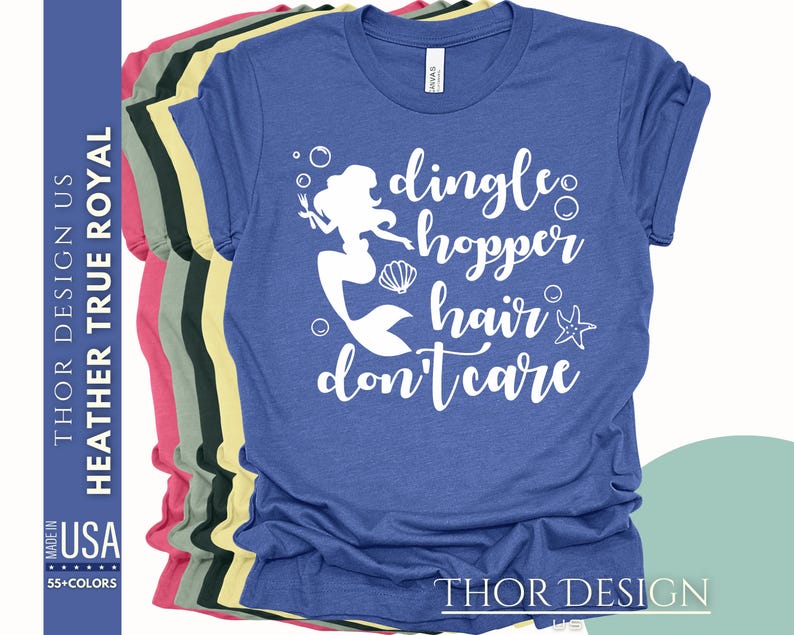 May include: A royal blue t-shirt with a white graphic of a mermaid with the text "dingle hopper hair don't care".