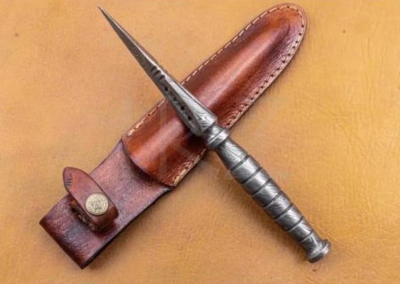 May include: A silver dagger with a leather sheath. The dagger has a textured handle and a pointed blade.