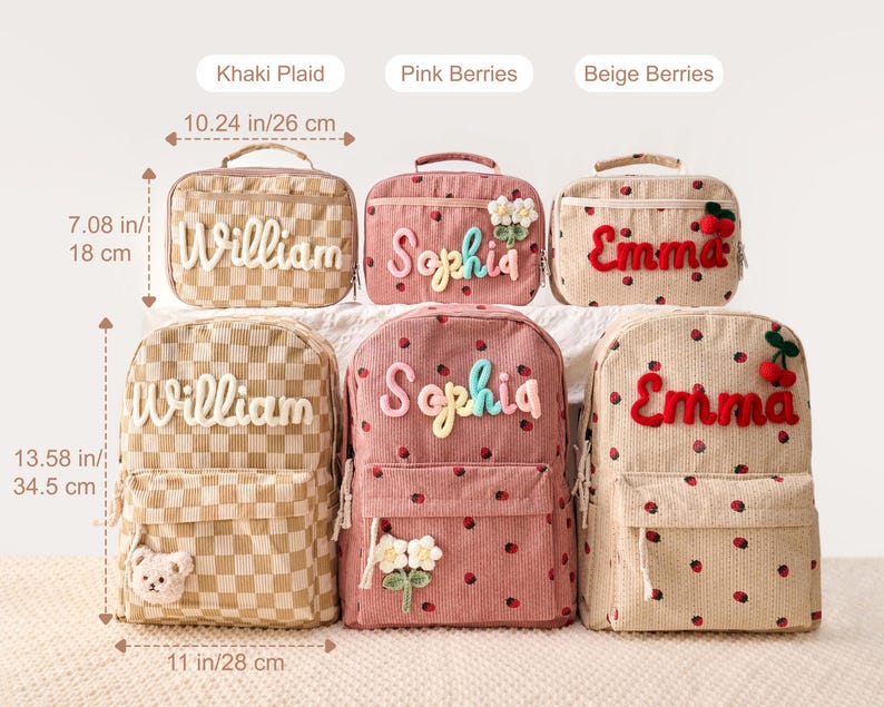May include: Three lunch bags and three backpacks in Khaki Plaid, Pink Berries, and Beige Berries patterns. Lunch bags measure 10.24 inches by 7.08 inches. Backpacks measure 13.58 inches by 11 inches. Each item features embroidered names and appliques.