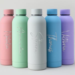 May include: Five colorful insulated water bottles in pink, green, white, blue, and purple. Each bottle has a matching cap and a name in silver script: Natalia, Amanda, Steven, Thomas, and Victoria. The bottles are cylindrical.