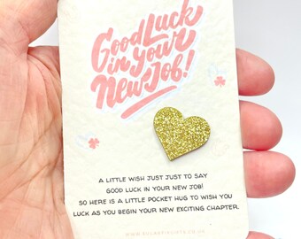 May include: A small card with the text "Good Luck in your New Job!" and a gold glitter heart. The card says "A little wish just just to say good luck in your new job! So here is a little pocket hug to wish you luck as you begin your new exciting chapter. www.sugarfixgifts.co.uk"