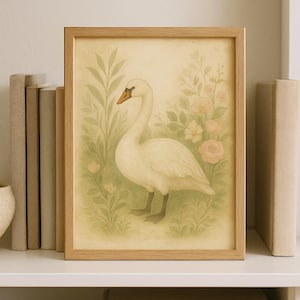 May include: A framed print depicting a white swan with an orange beak, surrounded by green leaves and pale pink flowers. The artwork is set against a light beige backdrop, within a natural wood frame, and displayed on a white shelf.