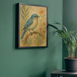 May include: A framed watercolour painting of a bluebird on a branch, set against flowers and foliage. The artwork is in a black frame and hangs on a green wall. A potted plant is nearby. The painting is approximately 30 cm x 40 cm.