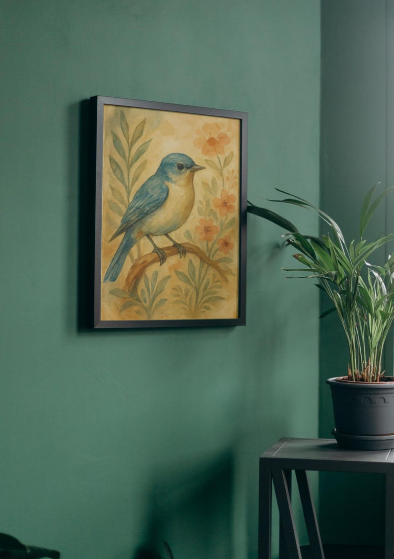 May include: A framed watercolour painting of a bluebird on a branch, set against flowers and foliage. The artwork is in a black frame and hangs on a green wall. A potted plant is nearby. The painting is approximately 30 cm x 40 cm.