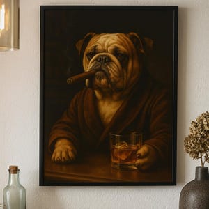 May include: Framed artwork featuring a distinguished bulldog in a brown robe, smoking a cigar, and holding a glass of whiskey with ice. The artwork has a dark background and is displayed in a black frame.