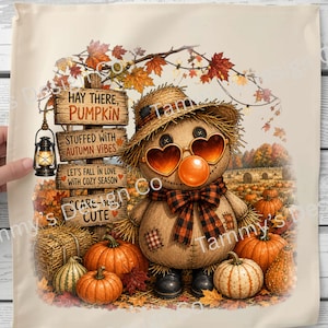 May include: A square fabric print featuring a scarecrow wearing a straw hat, heart-shaped sunglasses, and a plaid bow tie. A wooden signpost displays the text: Hay There, Pumpkin, Stuffed With Autumn Vibes, Let's Fall In Love With Cozy Season, Scare-ously Cute.