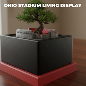 May include: A set of three ceramic mugs with a speckled, matte finish in cream, light grey, and dark grey. Each mug has a minimalist design and a rounded handle.