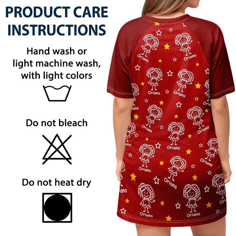 May include: A red t-shirt dress with a pattern of white cartoon figures, stars, and the name "Oriana." The dress has short sleeves and a crew neck. The product care instructions are also visible.