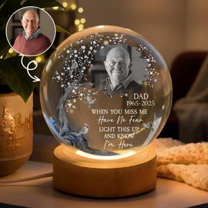 May include: A spherical glass night light on a cylindrical wooden base. The glass features an etched portrait of an older man, a tree with birds, and the text: DAD 1965-2025 WHEN YOU MISS ME Have No Fear LIGHT THIS UP AND KNOW I'm Here.