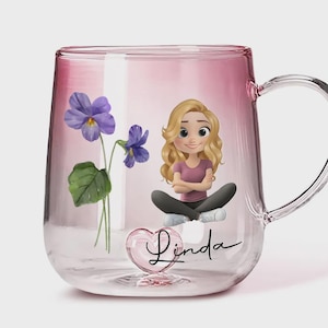 May include: A clear glass mug with a pink gradient. The mug features a cartoon illustration of a blonde woman, purple flowers, and the name "Linda" in script. The mug has a handle.