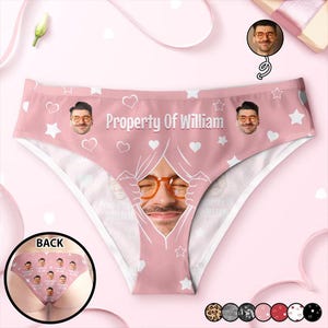 May include: Pale pink underwear featuring a repeating pattern of white hearts and stars. The text "Property Of William" is printed across the front. A man's face is printed on the front. A small image of the back of the underwear is in the lower left corner.