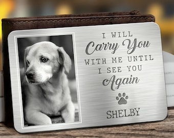May include: A silver metal memorial plaque with a black and white photo of a dog. The plaque reads "I will carry you with me until I see you again" and "SHELBY".