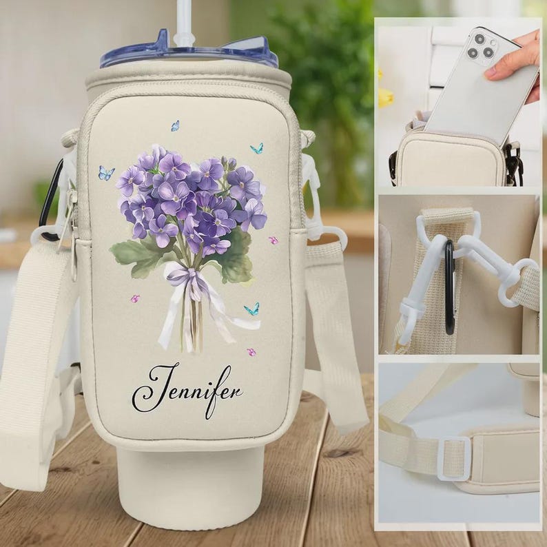 May include: Beige water bottle carrier with a purple floral design and the name "Jennifer" in script. The carrier has a shoulder strap, a phone pocket, and a straw lid. The floral design includes butterflies.