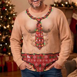 May include: A beige long-sleeve jumper featuring a realistic print of a bare chest with a red Christmas-themed tie and a red patterned waistband. The design includes colourful string lights draped around the neck, tie, and waist area.