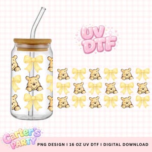 May include: A clear glass tumbler with a bamboo lid and a glass straw. The tumbler features a pattern of yellow bows and a cartoon bear. The words "UV DTF" are in pink bubble letters.
