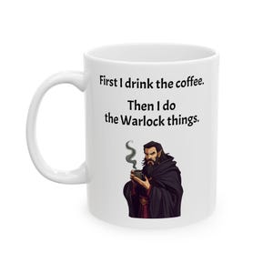 May include: White ceramic mug with a black and white illustration of a man with a beard holding a cup of coffee. The text on the mug reads "First I drink the coffee. Then I do the Warlock things."